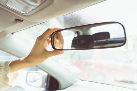 a woman hand adjust the mirror