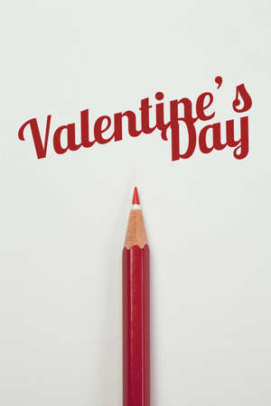 Red pencil and a red heart with valentine wordの写真素材