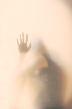 Blurred and Vintage tone of Mystic silhouette of woman asking for help