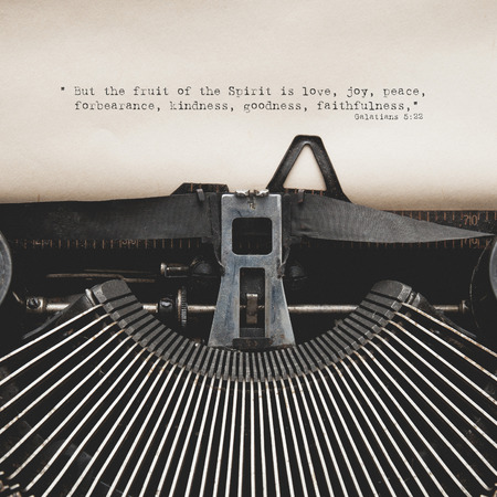 Antique typewriter with aged textured paper sheet. Bible verse of Galatiansの写真素材