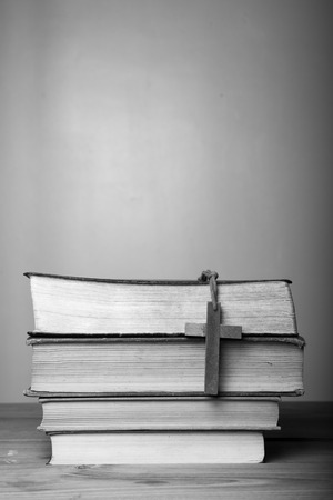 Closeup of wooden Christian cross necklace next to holy Bibleの写真素材