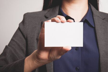 Businesswoman showing and handing a blank business card.の写真素材
