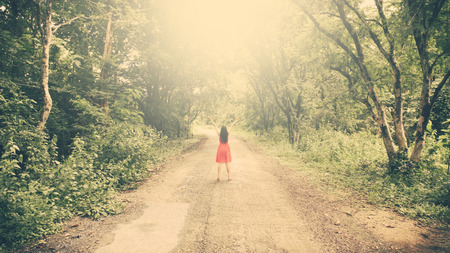 vintage tone of woman on a summit with upraised arms in the forest tunnel, Praise for GOD.の写真素材