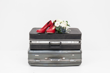 suitcase with shoes, and flower ready for travelの写真素材