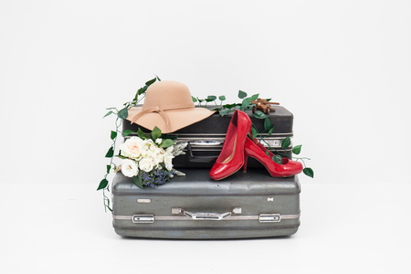suitcase with red shoes, and hat ready for travelの写真素材