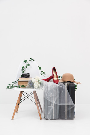 suitcase with shoes, and flower ready for travelの写真素材