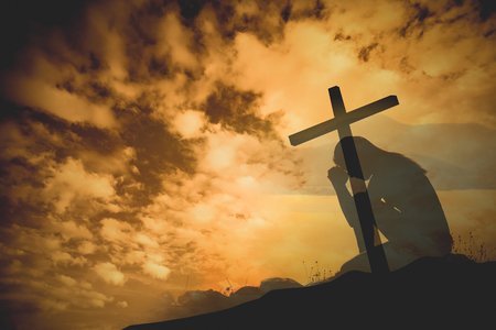 Praying with cross backgroundの写真素材