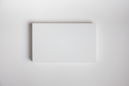 Mockup of business cards fan stack at white textured paper background.の写真素材