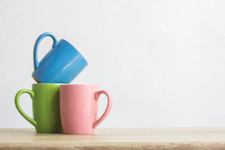 Colorful cup of coffee on a wooden tableの写真素材