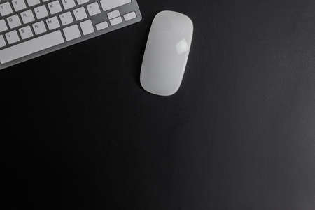Working items, keyboard and mouse mock up on a dark background.の写真素材