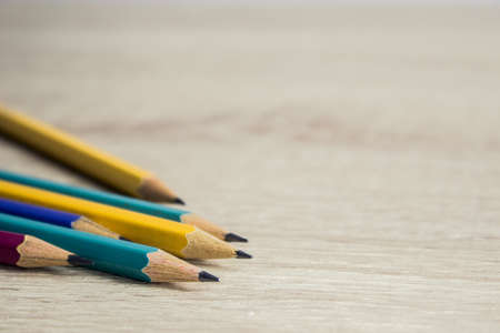 Colorful pencils on a wooden table, creative concept.の写真素材