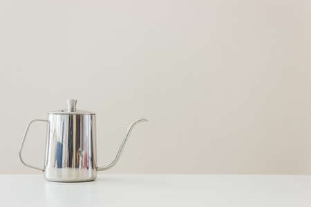 A silver kettle on table.の写真素材