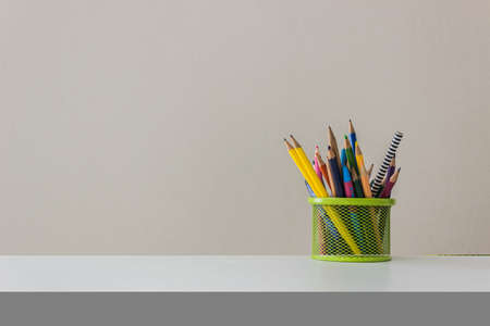 Colorful pencil on table over the light wall.の写真素材