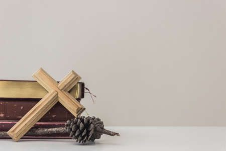 A wooden cross and holy bible on table.の写真素材