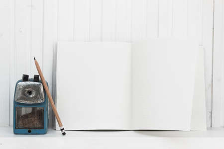 A pencil sharpener with pencil on table with a copy space.