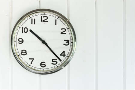 A clock on white wall.の写真素材