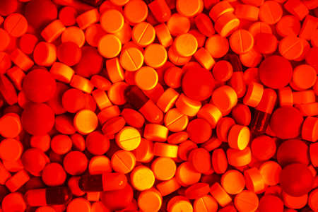 Red vivid pills using for a background.の写真素材