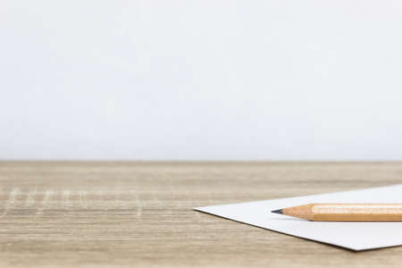 A pencil on a white paper on table.