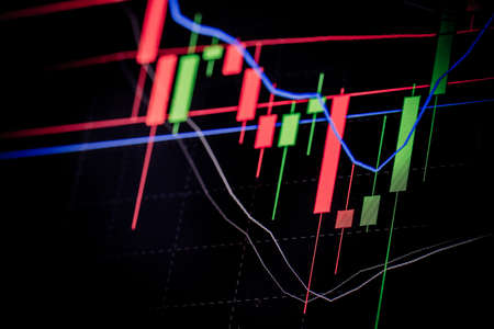 A stock market graph on a black background.の写真素材