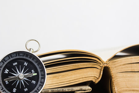 A black compass over the book with light wall.の写真素材