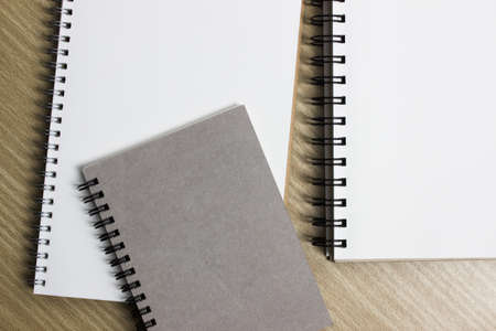 A white notebook on a wooden table.