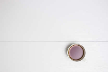 A cup of coffee on a white table.の写真素材