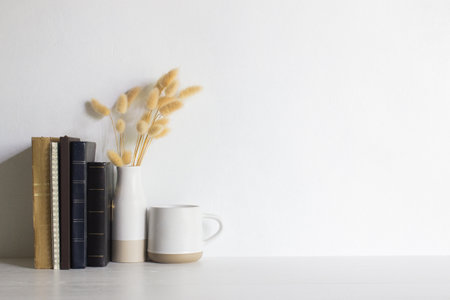 Minimal reading concept with books, coffee cups and flowers on wooden table.の写真素材