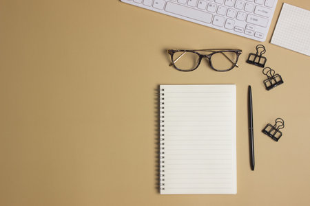 To do list with black notebook, pen, computer over the brown background.の写真素材