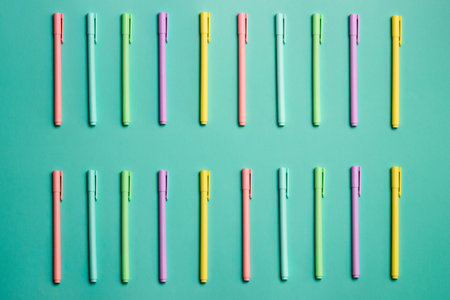 Close up of colorful pencils over the green background.の写真素材