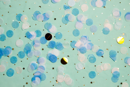 Blue, white and gold paper over glitter green background.の写真素材