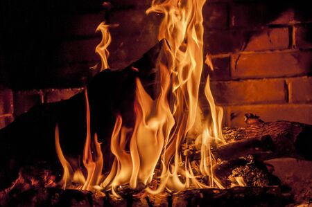 log is burning in fireplaceの写真素材