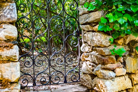 metallic door in the woods with stony sidesの写真素材