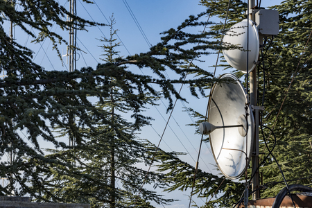 Communication towers, antennas and dishes over the mountainの写真素材