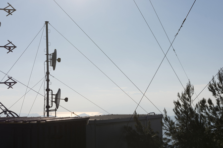 Communication towers, antennas and dishes over the mountainの写真素材