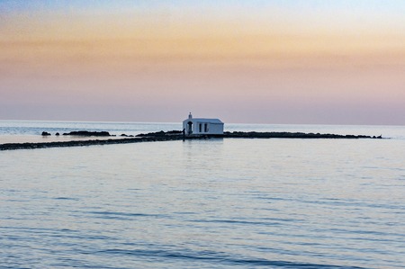 Little church at the sea during sunset at crete islandの写真素材