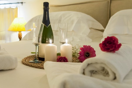 romance in bed with champagneの写真素材