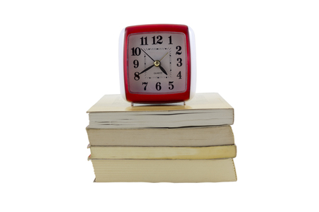 old clock with stack of booksの写真素材