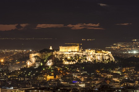 night shot of acropolis with part of athens cityの写真素材