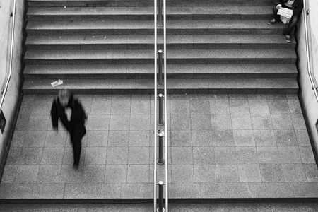 beggar siting on stairs in metro station in Athensの写真素材