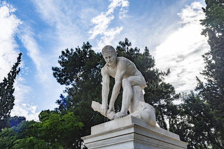 young male statue while try's to break a piece of woodの写真素材