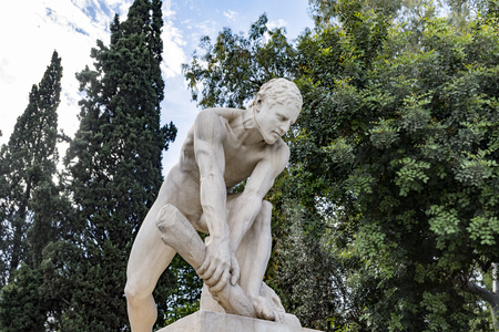 young male statue while try's to break a piece of woodの写真素材