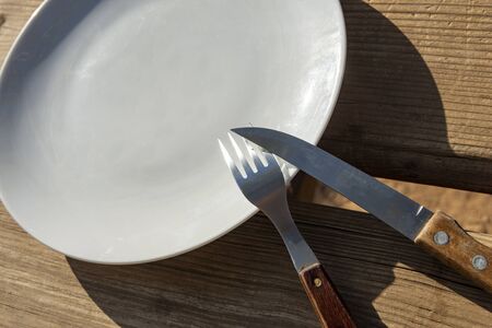 Empty plate with knife and fork - food outside the house project