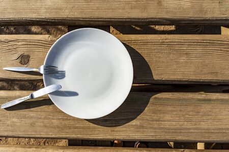 Empty plate with knife and fork - food outside the house project