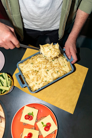 Man serving pasta with a spoon on a restaurantの写真素材