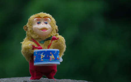 Toy monkey playing drum.の写真素材