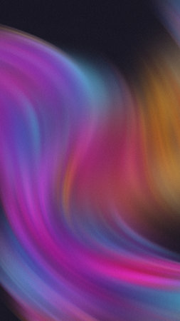 Swirling abstract gradient of vibrant purple blue pink and orange colors with a soft textured effect.の写真素材