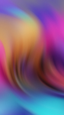 Abstract swirling gradient of pink yellow purple and blue colors with a soft textured effectの写真素材