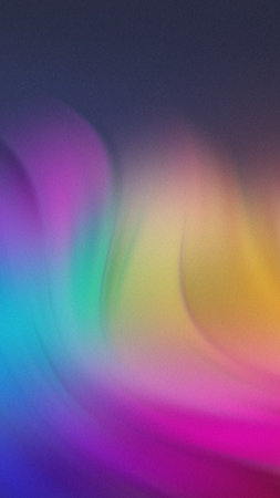 Softly blended abstract background with swirling waves of purple blue green yellow and pink hues.の写真素材