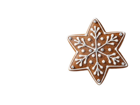 A close-up of a beautifully decorated gingerbread snowflake cookie with intricate white icing details, set against a clean white background. Perfect for holiday baking and festive celebrations.の素材