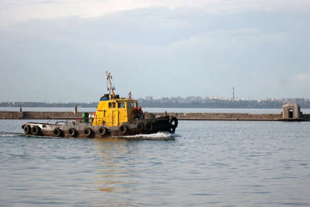 Moving tugboat in marinaの写真素材